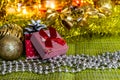 Colorful small gift boxes with gifts among Christmas tinsel and shiny toys and decorations Royalty Free Stock Photo