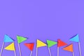 Colorful small paper flags at bottom on purple background