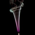 Colorful smoke of incence stick isolated at black background Royalty Free Stock Photo