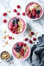 Colorful smoothie bowls topped with fresh berries and granola, AI Generated.