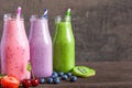 Colorful smoothies in bottles, healthy detox vitamin diet or vegan drinks with fruits, berries and straws Royalty Free Stock Photo