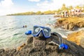 A Colorful snorkle or diving mask located on the rocks with snorkling group on the back Royalty Free Stock Photo