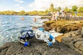 A Colorful snorkle or diving mask located on the rocks with snorkling group on the back Royalty Free Stock Photo