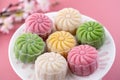 Colorful snow skin moon cake, sweet snowy mooncake, traditional savory dessert for Mid-Autumn Festival on pastel pale pink