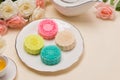 Colorful snow skin mooncake with tea pot on pink background