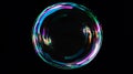 Colorful soap bubble floating against a dark background, showcasing vibrant reflections and intricate patterns, creating a Royalty Free Stock Photo
