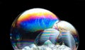 Colorful soap bubbles on a black background Royalty Free Stock Photo