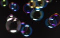 Colorful soap bubbles float in the dark. Abstract on black background Royalty Free Stock Photo