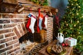 socks for a gift from Santa Claus hang on the fireplace. a large christmas tree