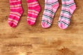 Colorful socks hanging against a wooden background Royalty Free Stock Photo