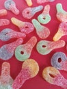 Colorful sour key candies on a pink background