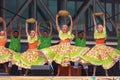 Colorful South American dancers performing with baskets