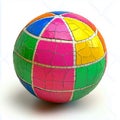 A colorful sphere with a cracked surface and patchwork design on a white background in bright light Royalty Free Stock Photo