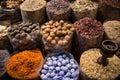 Colorful spices nuts dried flowers minerals and pestle for cooking at open air spice market Royalty Free Stock Photo