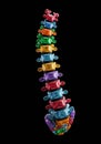 Colorful, spine-like structure made of stacked rectangular segments in bright hues: Royalty Free Stock Photo