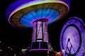 Colorful Spinning Swings, Ferris Wheel at Night Royalty Free Stock Photo