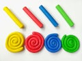 Colorful spiral plasticine, multicolored sticks clay dough, white background