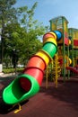 Colorful spiral tube slide at public playground . Royalty Free Stock Photo