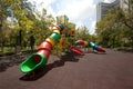 Colorful spiral tube slide at public playground . Royalty Free Stock Photo