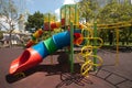 Colorful spiral tube slide at public playground . Royalty Free Stock Photo