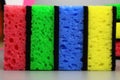 Colorful sponges, Washcloths for cleaning or washing dishes in a row on a gray background