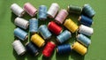 Colorful spools of thread arranged on a green fabric background Royalty Free Stock Photo