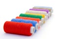 Nine brightly colored spools of threads for sewing Royalty Free Stock Photo