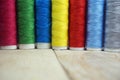 Colorful spools of thread on wooden table Royalty Free Stock Photo