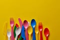 Colorful spoons on a yellow background. Royalty Free Stock Photo