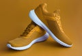 Colorful sport shoes on mustard color backround