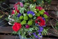 Colorful spring bouquet from fresh cut flowers - anemone coronaria, chrysanthemums, sea lavender - flowers gift. Royalty Free Stock Photo