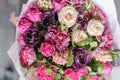 Colorful spring colors. the work of the florist at a flower shop. Purple and pink bouquet of beautiful flowers on wooden Royalty Free Stock Photo