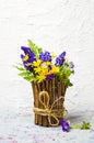 Colorful spring flowers in a rustic vase