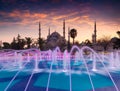 Colorful spring sunset in Sultan Ahmet park in Istanbul, Turkey, Europe. Colorful fountain on the background of the Loonic Blue M Royalty Free Stock Photo
