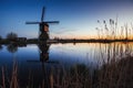 Colorful spring sunset traditional Dutch windmills canal in Rott
