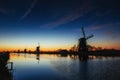 Colorful spring sunset traditional Dutch windmills canal in Rott