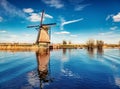 Colorful spring view of canal in Netherlands. Famous Dutch windmills at Kinderdijk, an UNESCO world heritage site. Traveling conce Royalty Free Stock Photo