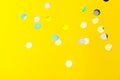 Colorful sprinkles over yellow background, decoration for holiday and party Royalty Free Stock Photo