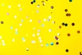 Colorful sprinkles over yellow background, decoration for holiday and party Royalty Free Stock Photo