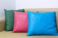 Colorful square leather pillow on brown sofa in living room , white wall background Royalty Free Stock Photo