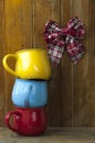 Colorful stack coffee cups on wood board