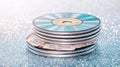 Colorful stack of compact discs with labels on a sparkling background Royalty Free Stock Photo