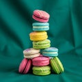 A colorful stack of macarons against a teal fabric background Royalty Free Stock Photo