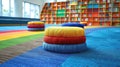 A colorful stack of pillows on a carpeted floor