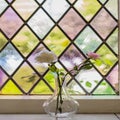 Colorful stained glass with flowers in vase in the light Royalty Free Stock Photo