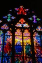 Colorful stained glass window with cross and icons in st. Vitus Cathedral, Prague.