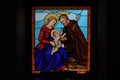 Colorful stained glass window icon of Jesus Christ, Mary and Joseph in Oratory of San Bartolomeo, Alpe Devero Royalty Free Stock Photo