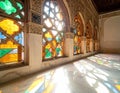 Colorful stained glass windows casting light patterns onto marble floor Royalty Free Stock Photo