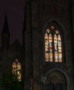 Colorful stained glass windows of a church are lit from inside Royalty Free Stock Photo