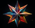 a colorful star made out of paper on a black background Royalty Free Stock Photo